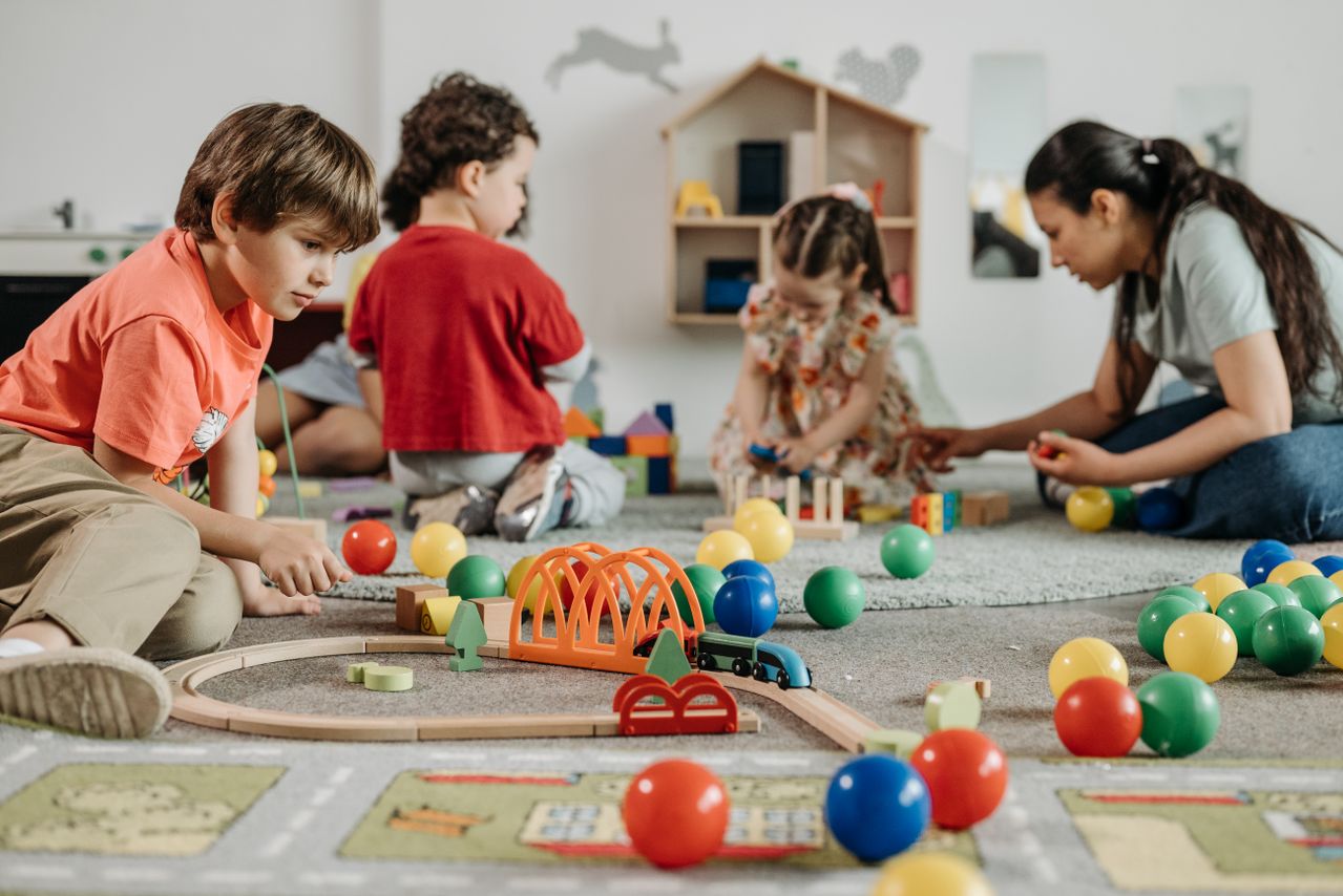 Nursery kids playing with toys